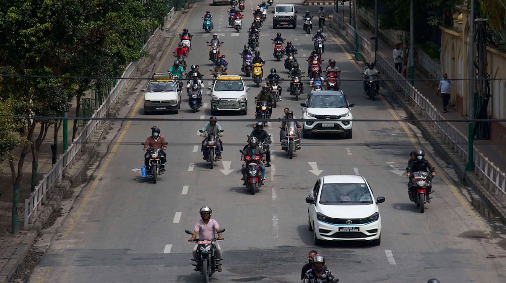 Vehicles move along the road after authorities lifted a days-long curfew imposed during anti-corruption protests sparked by a short-lived social media ban in Kathmandu, Nepal, Saturday, Sept. 13, 2025. (AP Photo/Niranjan Shrestha)