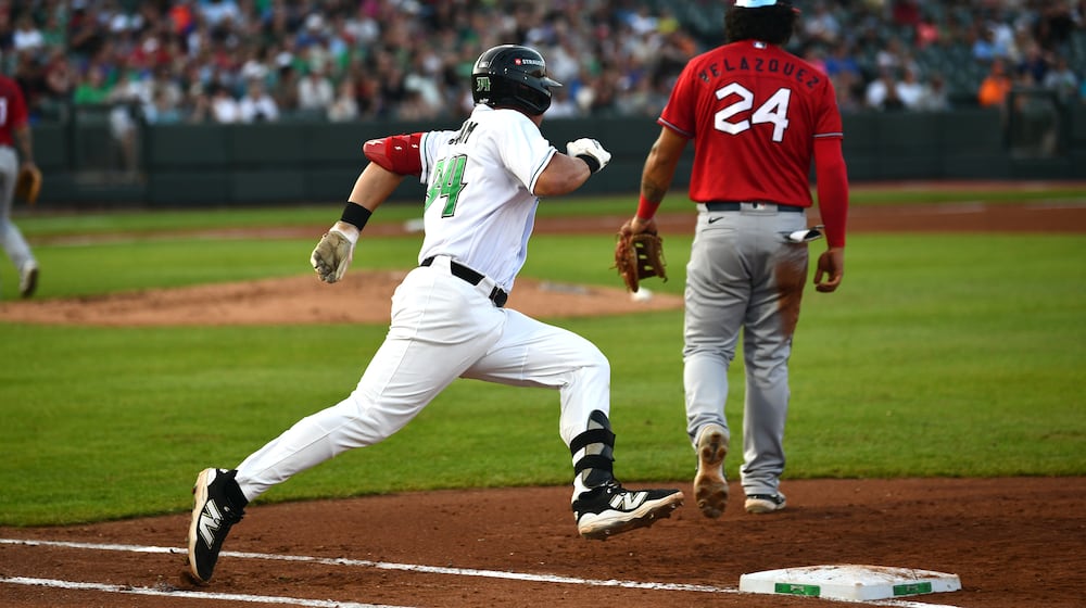 Carter Graham rounds first on a double that helped lead to the Dragons' first run in the fourth inning Saturday night at Day Air Ballpark. JEFF GILBERT/CONTRIBUTED