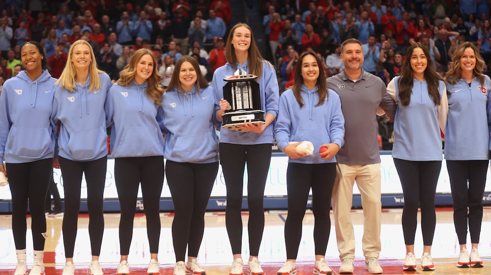 The Dayton volleyball team is honored during a men's basketball game against Saint Louis on Tuesday, March 4, 2025, at UD Arena. David Jablonski/Staff