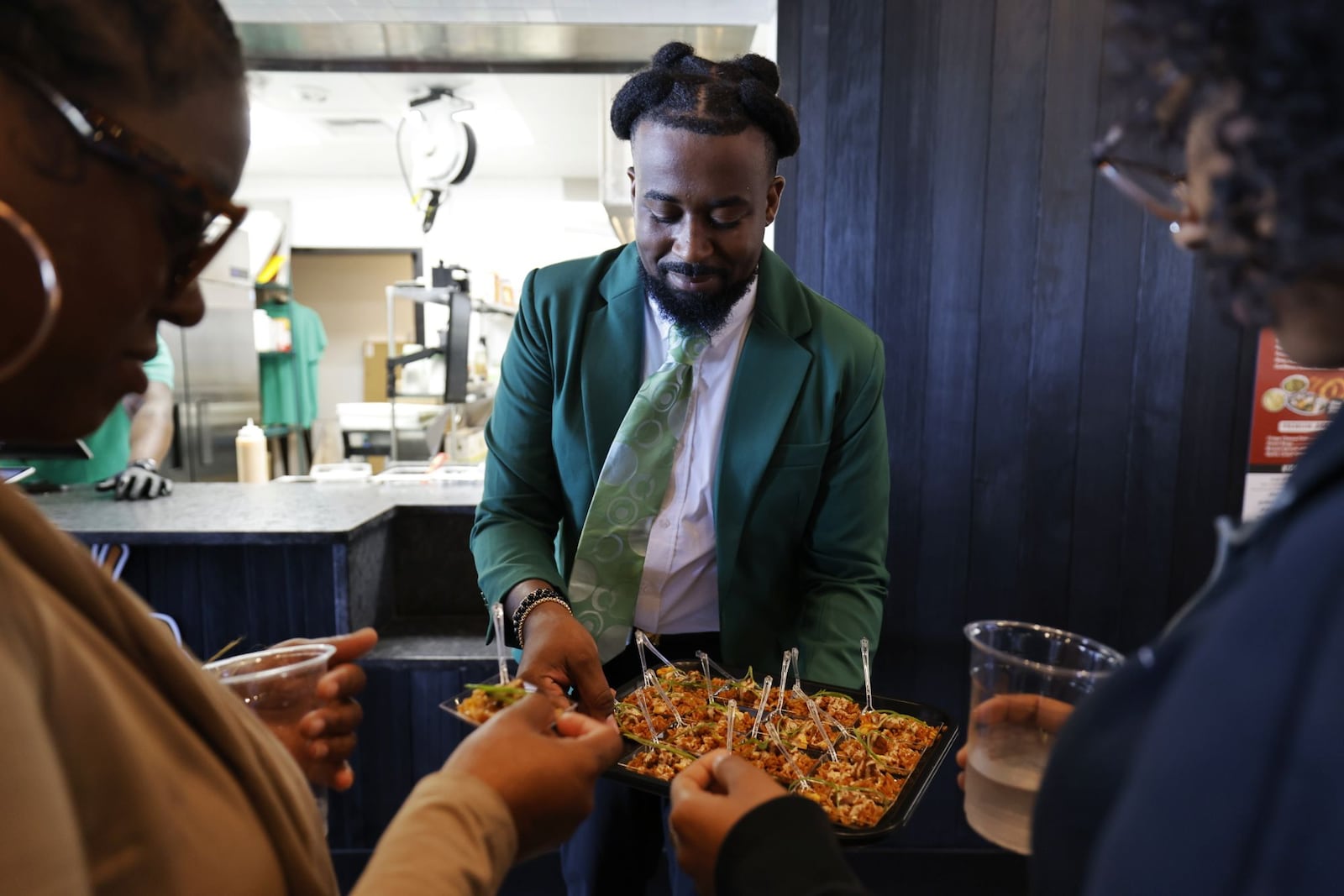Chef Marcus Johnson, from Rice Life, serves samples during the grand opening of Liberty Collective Wednesday, Sept. 10, 2025 in Liberty Township. NICK GRAHAM/STAFF