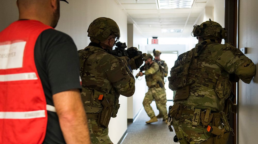 Defenders from the 88th Security Forces Squadron clear a hallway during an active-shooter exercise at Wright-Patterson Air Force Base.  U.S. AIR FORCE PHOTO/JAIMA FOGG