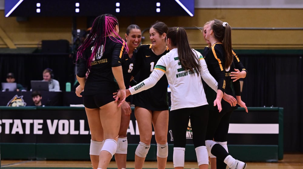 The Wright State University volleyball team celebrates after scoring a point during their game against IPFW last season in Fairborn. JOSEPH R. CRAVEN/WRIGHT STATE ATHLETICS
