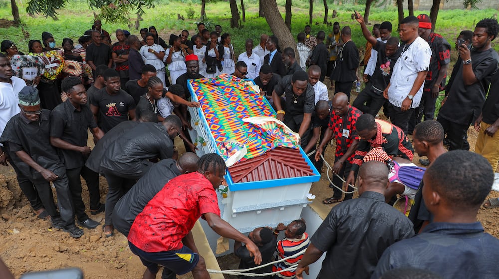 The fantasy coffin of the late Robert Nii Anang Obodai, a former school proprietor, is lowered into his grave in Accra, Ghana, Saturday, July 26, 2025. (AP Photo/Misper Apawu)