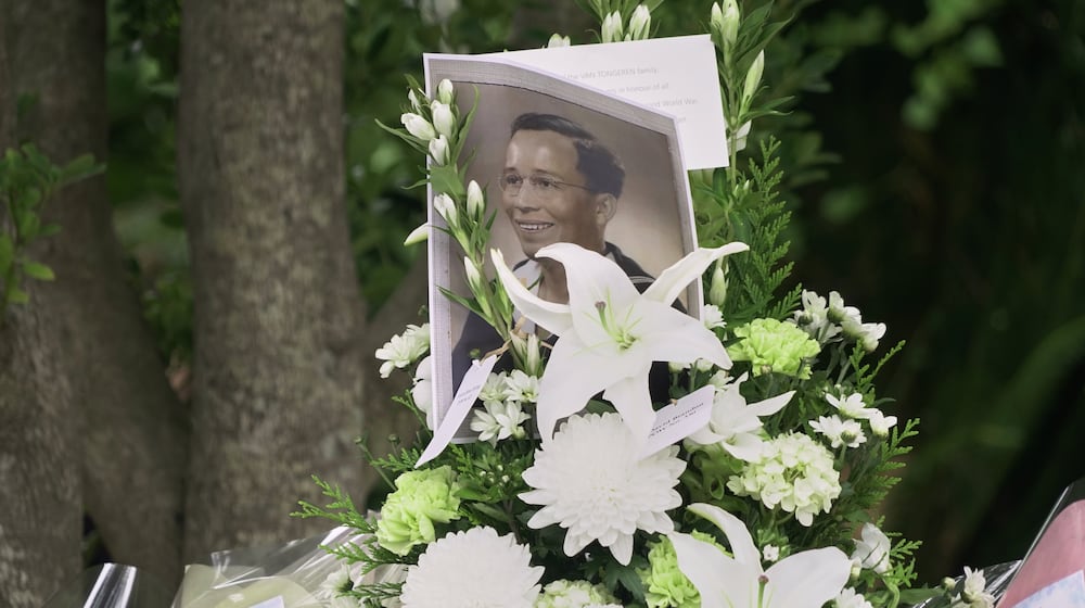 The portrait of a Dutch soldier who was held in wartime prison camps in Nagasaki, is placed by flowers during a ceremony for the victims of the Fukuoka POW Camp No. 2 in Koyagi, Nagasaki city, western Japan, Saturday, Sept. 13, 2025. (AP Photo/Mayuko Ono)