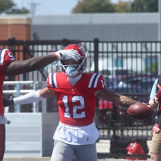 Dayton's Zachary McDowell, left, congratulates Gavin Lochow after a touchdown catch against Thomas More on Saturday, Sept. 6, 2025, at Welcome Stadium. David Jablonski/Staff