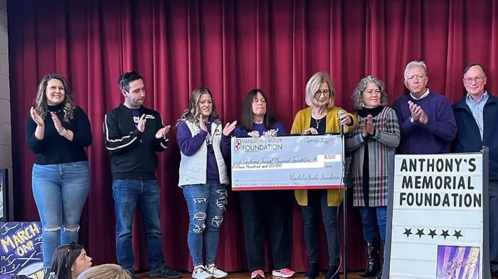 Susan Trissell, fourth from left, keeps her son Anthony's memory alive through a memorial foundation that supports Vandalia-Butler marching band members, along with a weekly music series each summer. CONTRIBUTED