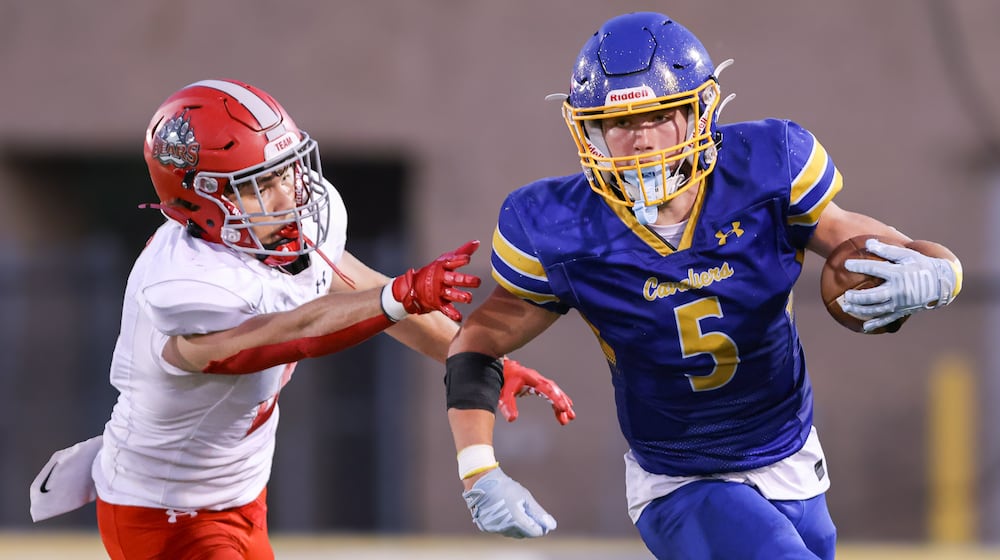 Lehman Catholic senior receiver Evan O'Leary runs with pressure from Northridge's Dylan Truesdale during a Three Rivers Conference game on Thursday, Sept. 11 at Sidney Memorial Stadium. BRYANT BILLING / STAFF