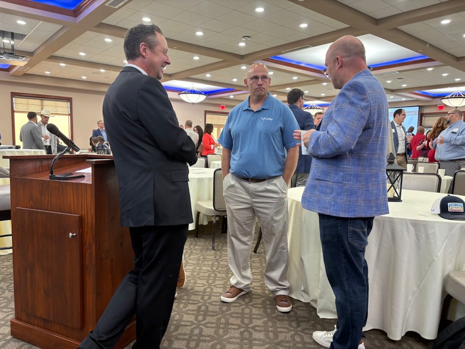 From left: David Bowman, co-CEO of The Ohlmann Group; Thomas Ubelhart, general manager of Joby Aviation's Joby Manufacturing of Ohio facility in Dayton; and Lydon Sleeper, Joby's strategic policy lead, in conversation Friday, Sept. 12, 2025 at the NCR Country Club. THOMAS GNAU/STAFF