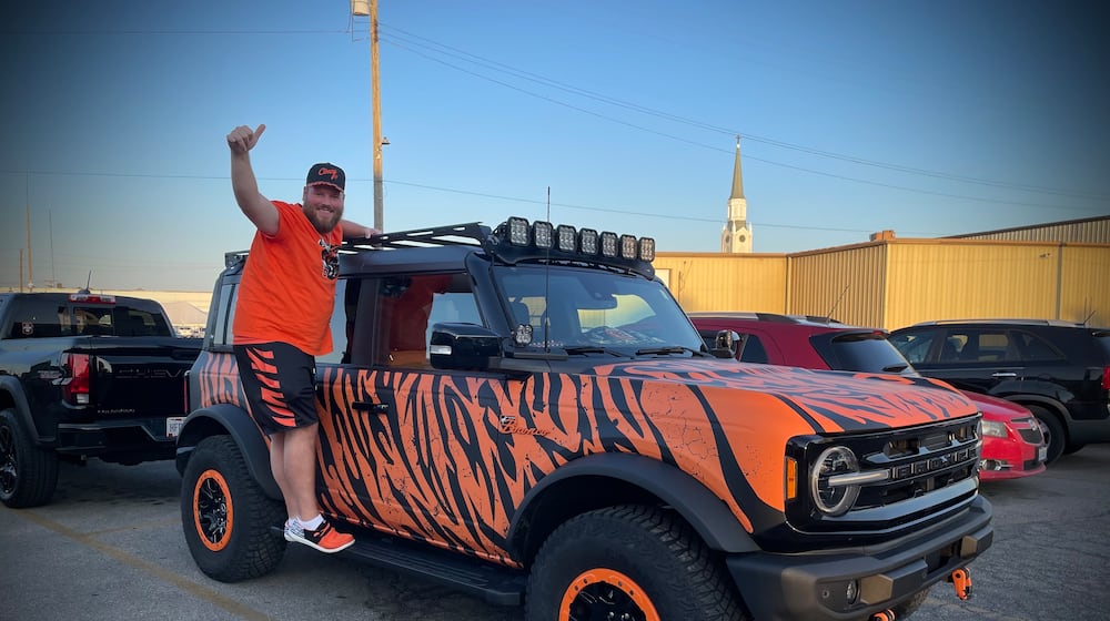 Adam Bushman of New Bremen drove his 2022 Ford Bronco that is decked out in tiger strips about an hour to the Troll Pub to hangout with other Bengals fans. NATALIE JONES/STAFF