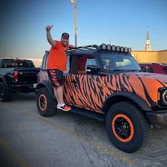 Adam Bushman of New Bremen drove his 2022 Ford Bronco that is decked out in tiger strips about an hour to the Troll Pub to hangout with other Bengals fans. NATALIE JONES/STAFF