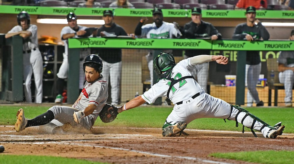 Dragons catcher John Michael Faile applies the tag in time on a throw from left fielder Anthony Stephan, but the ball got away and the run scored during their game against Lansing on Wednesday, Sept. 3 at Day Air Ball Park. JEFF GILBERT/CONTRIBUTED