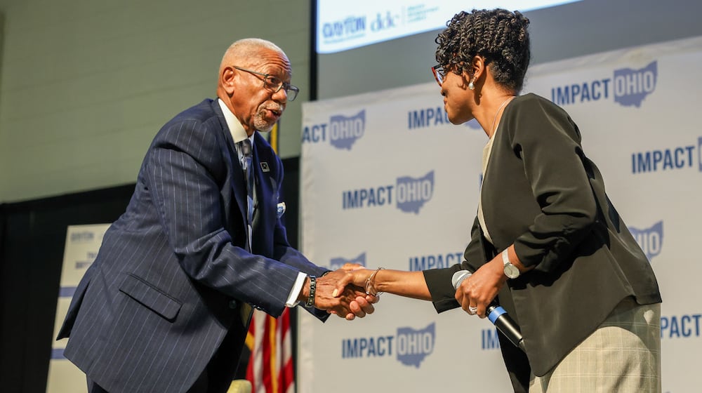 Dayton Mayor Jeffrey Mims Jr. shakes hands with city commissioner Shenise Turner-Sloss following a panel in the Ohio Chamber's 2025 Dayton Regional Impact Ohio Conference on Tuesday, Aug. 26, in the Apollo Room in the Student Union at Wright State University. Turner-Sloss is challenging Mims in November's election. BRYANT BILLING / STAFF