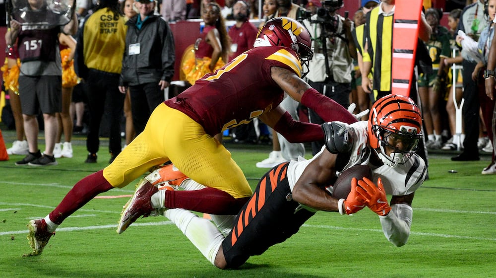 Cincinnati Bengals wide receiver Mitchell Tinsley, right, catches a touchdown pass as Washington Commanders cornerback Bobby Price defends during the first half of a preseason NFL football game Monday, Aug. 18, 2025, in Landover, Md. (AP Photo/Nick Wass)