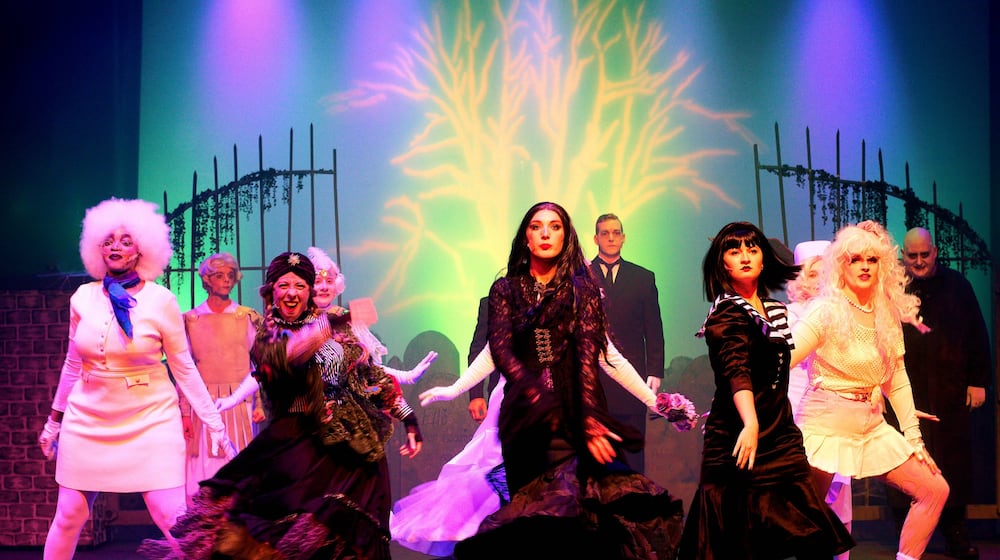 Center left to right: Kelli Myers (Grandma), Taylor Nelson (Morticia) and Brianna Wolfe (Wednesday) and the cast of Dayton Playhouse's production of "The Addams Family." Photo by Ray Geiger