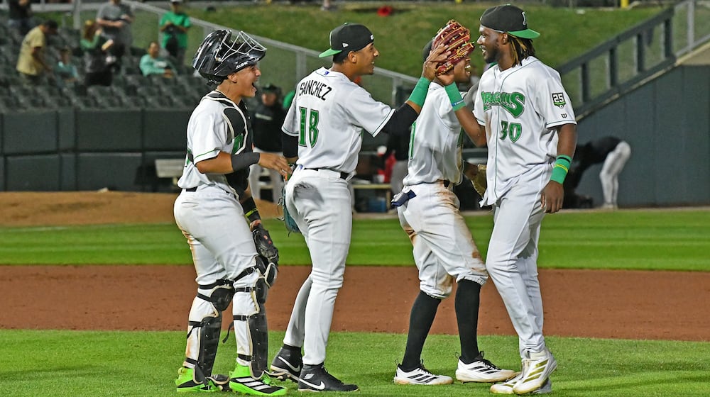 Yerlin Confidan, who singled in the winning run, is greeted by Carlos Sanchez and catcher Diego Omana after catching the final out Tuesday, Sept. 3 at Day Air Ballpark. JEFF GILBERT/CONTRIBUTED