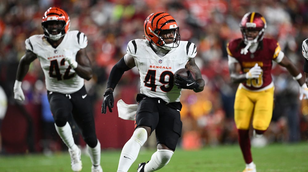 Cincinnati Bengals linebacker Barrett Carter runs with the ball after intercepting a pass during the first half of a preseason NFL football game against the Washington Commanders Monday, Aug. 18, 2025, in Landover, Md. (AP Photo/Nick Wass)