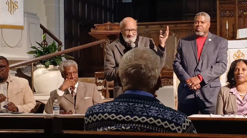Ohio NAACP president Tom Roberts, left, stands with Dayton NAACP president Derrick Foward, right, during a listening session at Grace United Methodist Church in March. FILE.