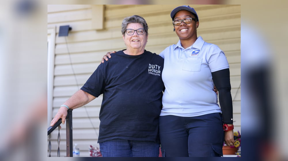 Dawnisha “Dee” Thompson-Newsome (right) has been named a Dayton Daily News Community Gem for her work as a mail carrier in Kettering. Last July she was delivering mail when one of the women on her route, Carla Nelson (left), fell on her front steps. BRYANT BILLING / STAFF