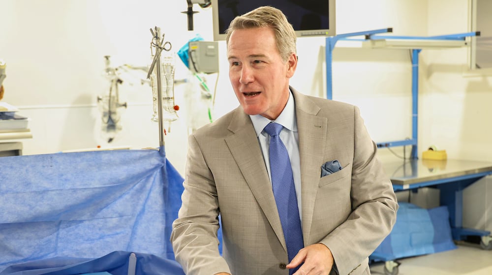 Sen. Jon Husted talks after stitching a mannequin's chest during a visit to Sinclair Community College on Wednesday, Aug. 13 at Ned J. Sifferlen Health Sciences Center. Husted promoted a recent change allowing Pell Grants to be used for workforce credentials. BRYANT BILLING / STAFF