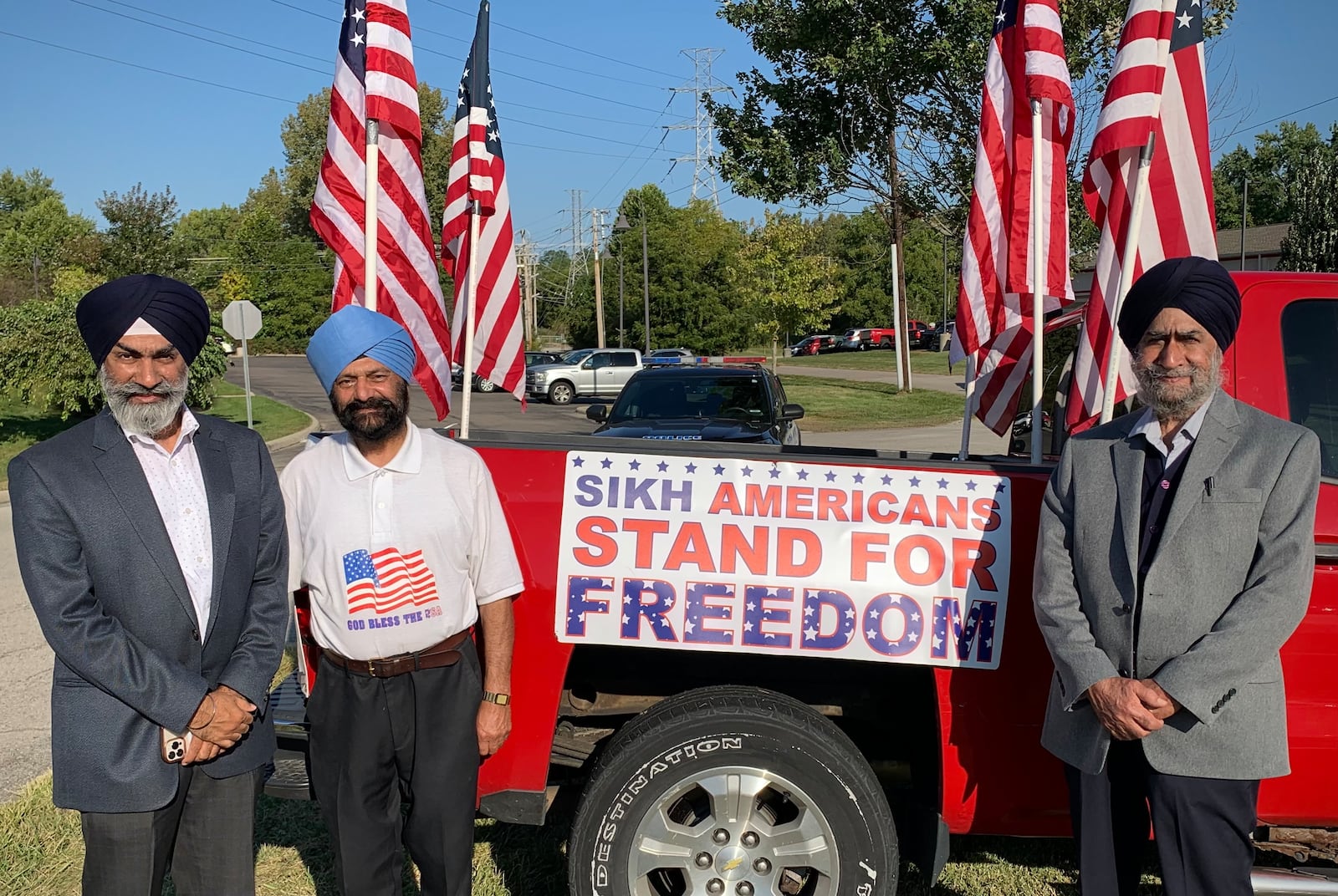 From left: Sameep Singh, Avtar Singh, and Charanjit Singh of the the Sikh Society of Dayton pose with a truck decorated for the commemoration of the Sept. 11, 2001 terrorist attacks. LONDON BISHOP/STAFF