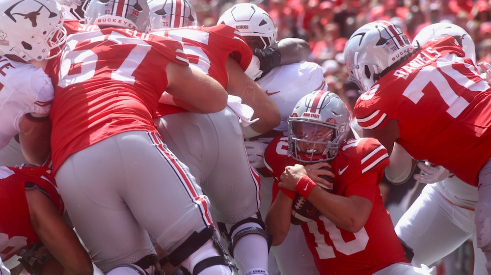 Ohio State's Julian Sayin runs the ball from near the goal line against Texas on Saturday, Aug. 30, 2025, at Ohio Stadium in Columbus. David Jablonski/Staff
